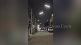Bizarre red moon seen from street in Thailand