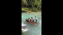 Wooden raft sinks as friends play at waterfall