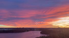 Glorious purple sunrise glows over Fresh Pond in Massachusetts