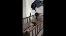 Little girl caught playing in crib in Newchapel, UK