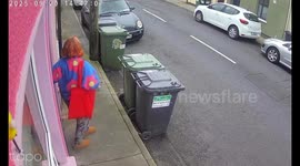 Flock of pigeons swarm woman outside store in Waterford, Ireland