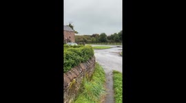 Vehicle floats on flooded road in Bradford, UK