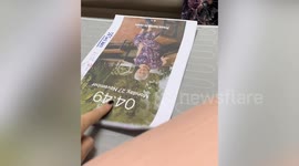 Granddaughter uses flashcards to teach grandmother how to use phone