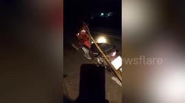Shocked rider finds python slithering over motorcycle