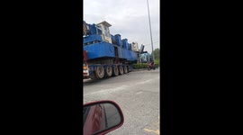 Bungling truck driver hits traffic lights and bursts tyre