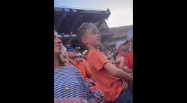 Excited boy throws shirt during football game in Auburn, Alabama, USA
