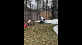 Brothers’ playful mishap on balance bike in Tulsa, Oklahoma, USA