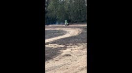 Boy races Staffordshire Bull Terrier on mini motocross bike in Sardegna, Italy