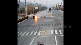 Bystanders smash windows of flaming vehicle with bare hands to rescue motorist following crash in China