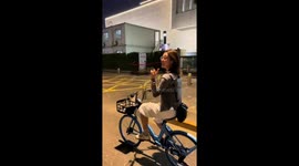 Woman loses balance and crashes into parked bicycles in Beijing, China