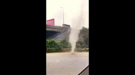 Dust devil tornado rips through road in Vietnam