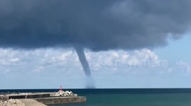 Waterspout tornado swirls over sea off Japan coast