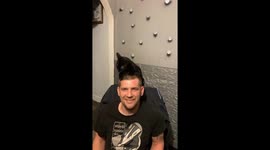 Playful Bombay cat scratches and licks man’s head in Chatham, England, UK