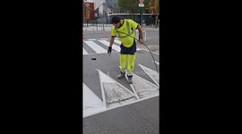 Parisian worker perfectly spray paints markings onto road