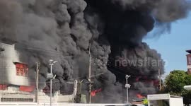 Fire engulfs oil and farm supply shop in eastern Thailand