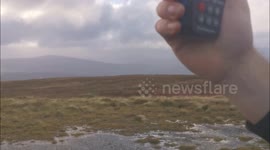Storm chasers struggle to stand as they attempt to record Storm Amy winds