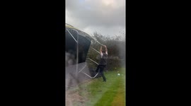 Man is nearly blown away by trying to hold down trampoline during storm Amy