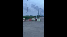 Jogger trips while trying to hurdle road barrier