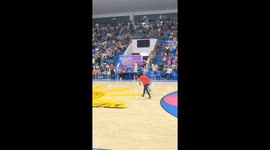 Grandfather scores three-point shot at basketball half-time competition
