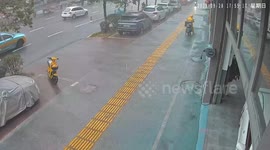 Electric motorcycle hits woman during heavy rain in Guangxi, China
