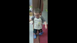 Upset little boy trips and falls over toy cart in Guangdong, China