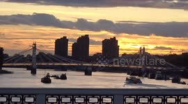 Dramatic golden sunset over the River Thames opening from Chelsea Bridge in London