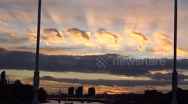 Mesmerising golden sunset over the River Thames viewed from Chelsea Bridge in London