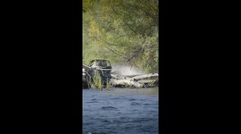 Mini jet boat hits log and ramps briefly on Rogue River in Oregon, USA