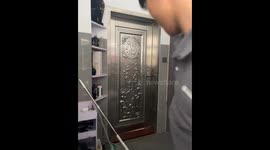 Man battles powerful typhoon winds while closing door in Guangdong, China