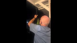 Hilarious moment dad's new hanging basket gadget snaps, sending flowers flying and daughters collapsing with laughter