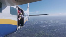 Group of 17 skydivers perform rare 'water drop' plunge into lake at 100mph