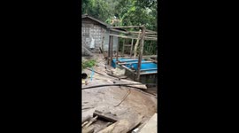 Muddy flood surges through homes in the Philippines