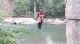 Life Threatened Crossing a Bridge Made of a Single Sheet of Iron in West Sumatra, Indonesia