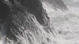Strong waves crash against the rocks and cliffs at Kynance Cove