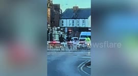 Woman ignores level crossing barriers - carries bike over tracks