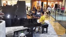 Young Piano player wows crowds in shopping center