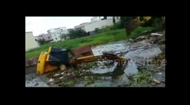 Digger falls into pond, driver lucky to escape