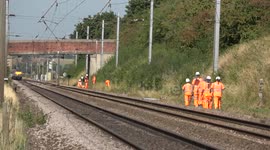 Hot railway lines, men working in 30 degree's heat, train passing 4K