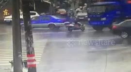 Woman crossing road on scooter narrowly escapes being killed by lorry