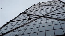 People abseiling down one of the towers in Bishopsgate, London
