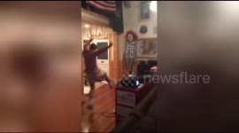 Sports fan loses it when team wins, smashes head through window