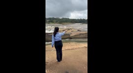 Woman Falls on Slippery River Bank