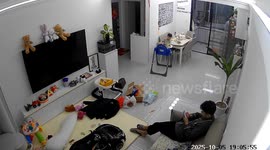 Toddler climbs out of high chair and falls as father sits on sofa