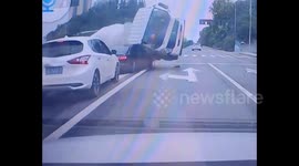 Cement tanker flips over and crushes nearby car, passengers miraculously survive