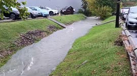 Creek swells into fast-flowing rapid after flash flooding in Lexington, Kentucky, USA