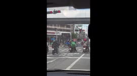 Motorcycle pillion passenger sparks concern by carrying another scooter