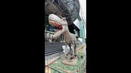 Giant model dinosaurs greet visitors to shopping mall in Bangkok