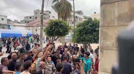 Gaza residents celebrate ceasefire announcement outside Al-Ahli hospital