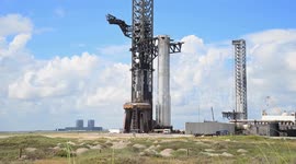 Booster 15.2 is transported from SpaceX Starbase production facilities to the launch pad and lifted with the mechazilla chopsticks prior to full stacking in Boca Chica, Texas