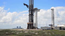 Booster 15.2 is transported from SpaceX Starbase production facilities to the launch pad and lifted with the mechazilla chopsticks prior to full stacking in Boca Chica, Texas